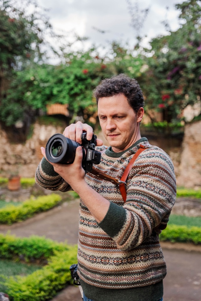 John Bunn holding a camera outdoors